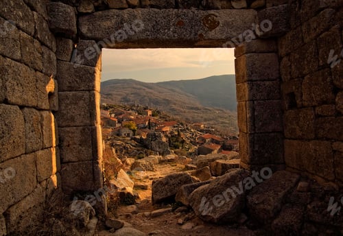 Preview: Ancient stone doorway framing a picturesque village
