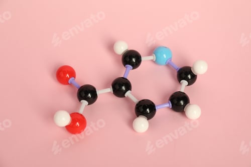 Preview: Molecule of niacin (vitamin B3) on pink background. Chemical model