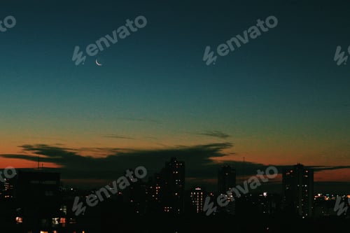 Preview: Crescent moon setting in the city