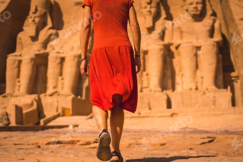 Preview: A Young Tourist In Red Dress Walking Towards The Abu Simbel Temple In Southern Egypt In Nubia Next