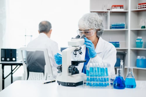 Preview: Female Scientist Using Microscope in Modern Laboratory
