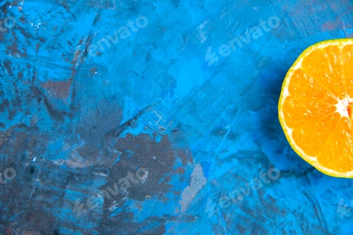 Preview: top half view cut orange on blue grey background free space