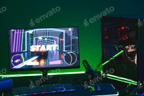 Preview: Composite of computer, keyboard with video game accessories with copy space on neon background
