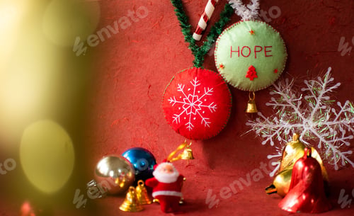 Preview: Closeup of beaded Christmas tree decorations on a red surface