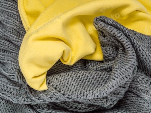 Preview: Knitted sweater or scarf as wool texture in trendy colors of year 2021 illuminating yellow and ultim