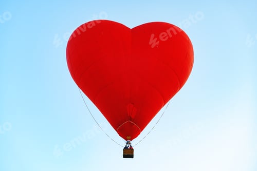 Preview: Red heart-shaped air balloon flying in the sky