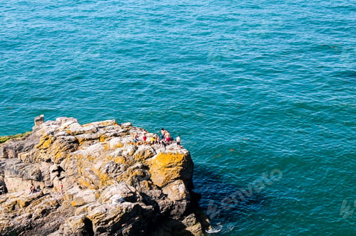 Preview: Aerial view of a group of friends on the cliff