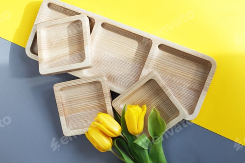Preview: wood empty plates for snack and flowers on color grey and yellow background