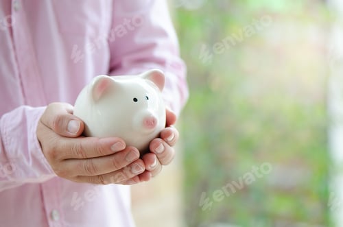 Preview: man hold piggy bank for investment ,save money or retire in future with copy space