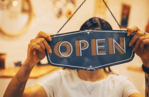 Preview: Barista waitress woman turning open sign board on glass door in coffee shop, retail store