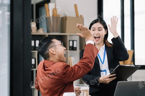 Preview: Happy creative business people are motivated, giving high five and celebration successful deal.