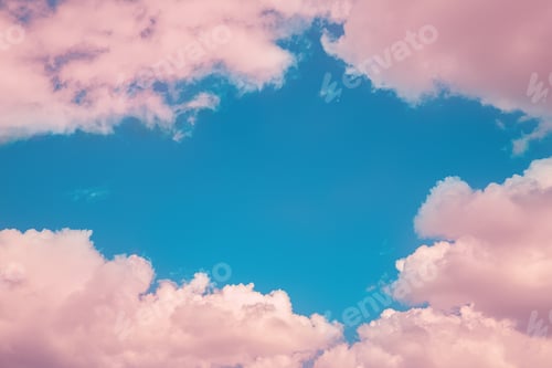Preview: Beautiful fabulous pink cumulus clouds in the blue sky at sunset. natural background