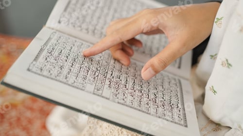 Reading religious text with hand pointing to page