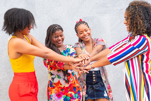 Preview: Happy multiracial youths celebrating a party together outside