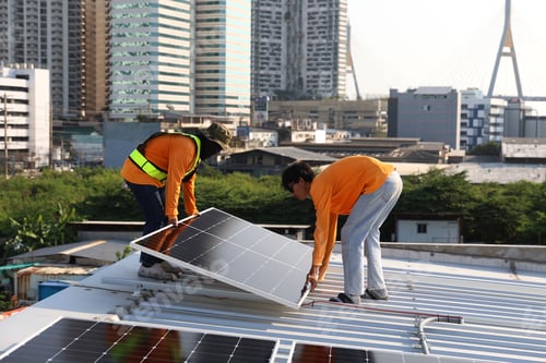 Preview: Technicians Install photovoltaic solar modules on roof of house.
