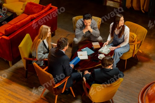 Preview: top shot in large beautiful hall office employees sitting on yellow chairs discuss a deal