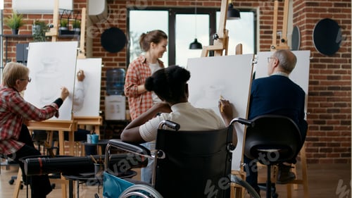 Preview: Young woman with disability learning to draw sketch on canvas