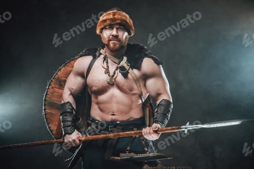 Preview: Shirtless viking armed with spear poses in smokey background