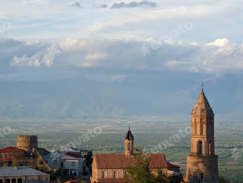 Preview: Church tower with other buildings against the background of mountains. Signagi, Georgia.