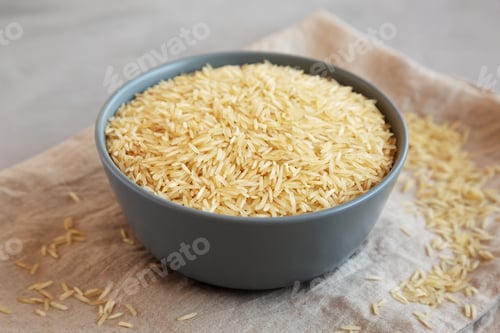 Preview: Dry Organic Indian Basmati Rice in a Bowl on a gray background, side view.