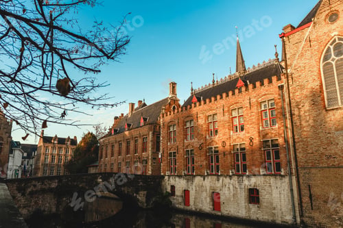 Preview: beautiful old traditional buildings and bridge over canal in brugge, belgium