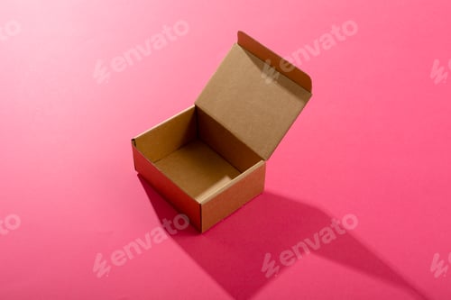 Preview: Composition of open empty cardboard gift box on pink background