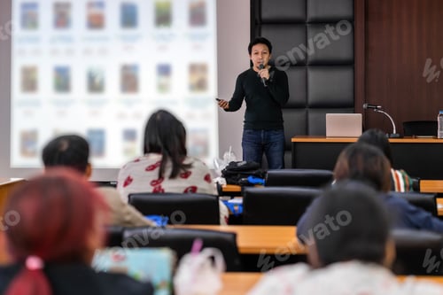 Preview: Asian Speaker or lecture with casual suit on the stage presenting via projector screen