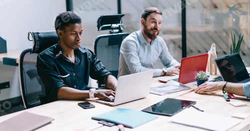 Preview: Diverse employees working in office with laptops