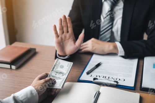 Preview: Business person refusing bribe given money by partner with anti bribery corruption concept.