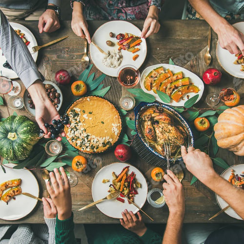 Preview: Friends eating at Thanksgiving Day table with turkey square crop