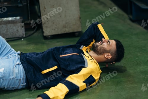 Preview: Warehouse worker sustains an injury after falling from a height while on duty in a factory.