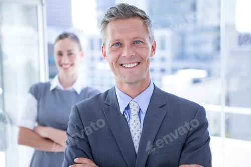 Preview: Businessman Smiling At The Camera While His Colleague Smiling In The Background