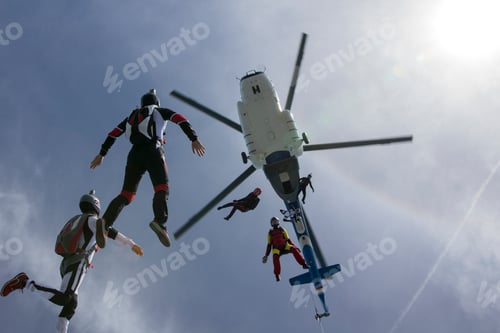 Preview: Low angle view of helicopter and six skydivers free falling, Siofok, Somogy, Hungary