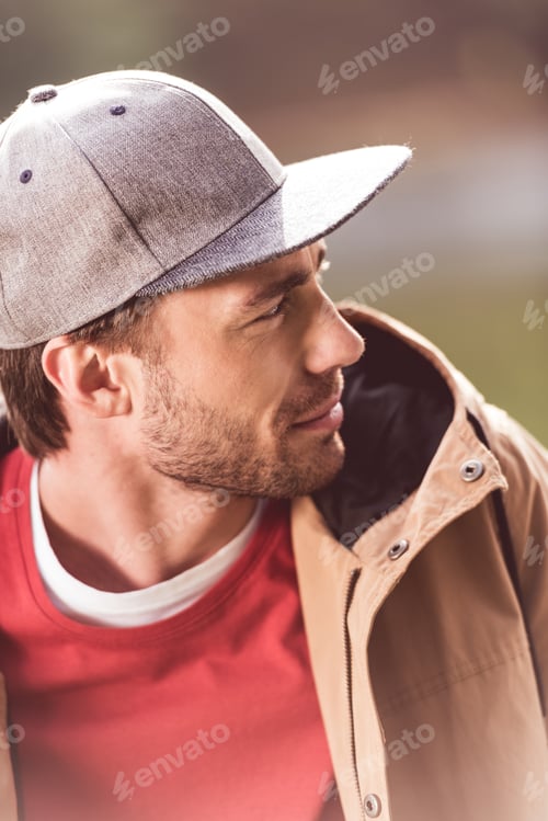 Preview: Close-up portrait of young bearded man traveler looking away