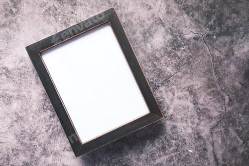 Preview: top view of empty frame on wooden background