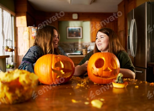Preview: two sisters looking at the pumpkin jack-o-lanterns they just made