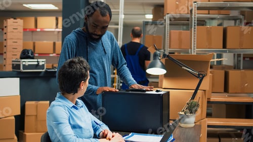 Preview: Small business owners using laptop to do shipment logistics work