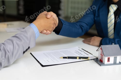 Preview: Businessman handshake after reaching a real estate deal.