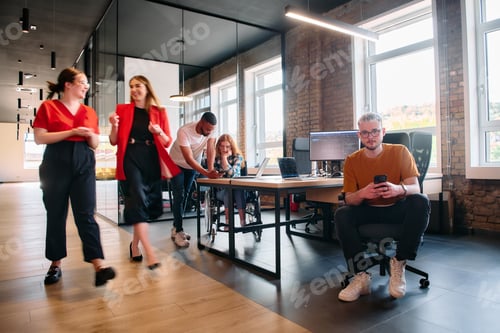 Preview: A diverse group of business professionals collaborates in a modern startup coworking center