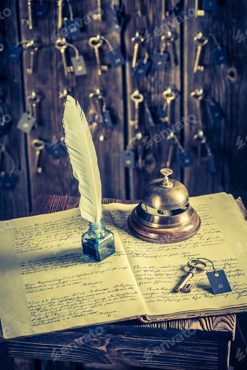 Preview: Old reception in hotel with guestbook and keys for rooms