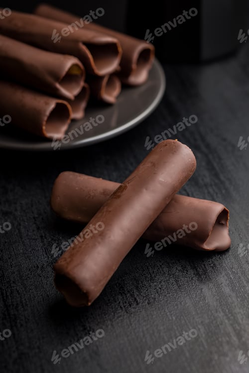 Preview: Chocolate Covered Wafers on a Dark Tabletop