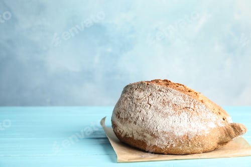 Preview: Fresh bread on table against color background. Space for text