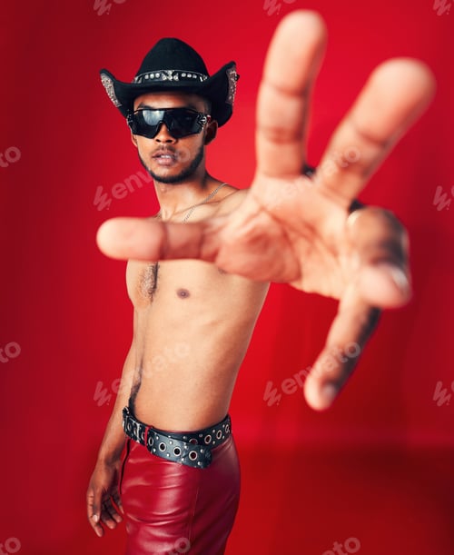 Preview: Gay, man and portrait with fashion, beauty and pride in studio red background with unique cowboy ae