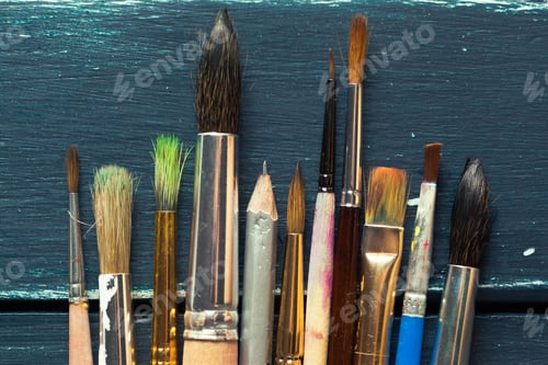 Preview: Paint brushes on wooden background