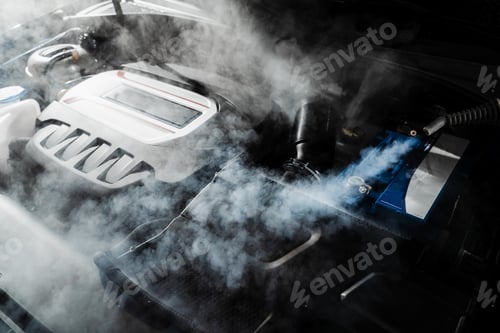 Preview: Steam cleaning car engine from dust and dirt in auto detailing service motor cleaned