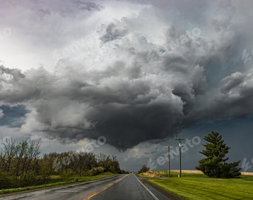 Preview: A lowering wall cloud forms over the roadway in Iowav