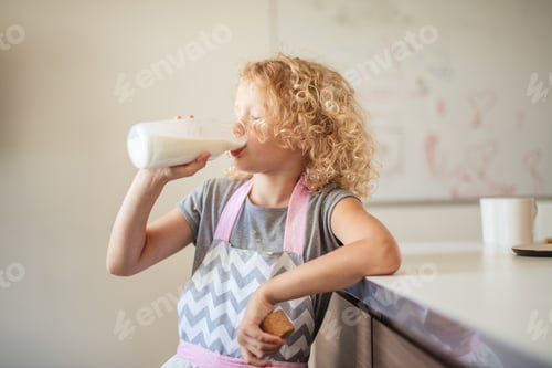 Preview: Cute little girl with glass of milk on color background