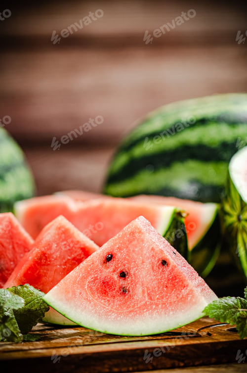 Fresh Watermelon Slices with Mint on Wood Table