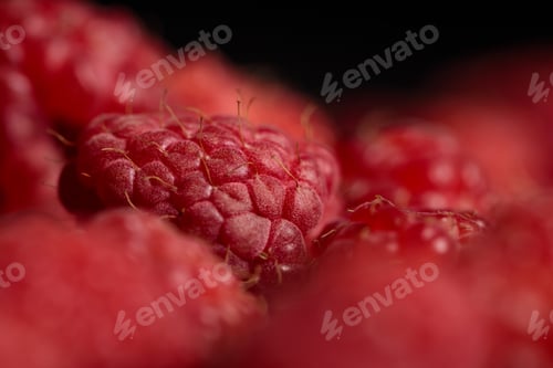 Preview: selective focus of delicious ripe raspberry isolated on black