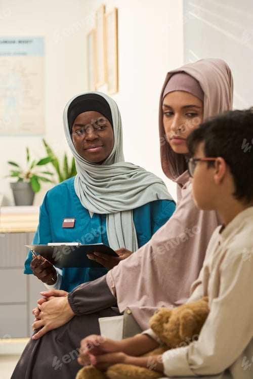 Preview: Muslim Medical Professional Consulting Family in Clinic Setting
